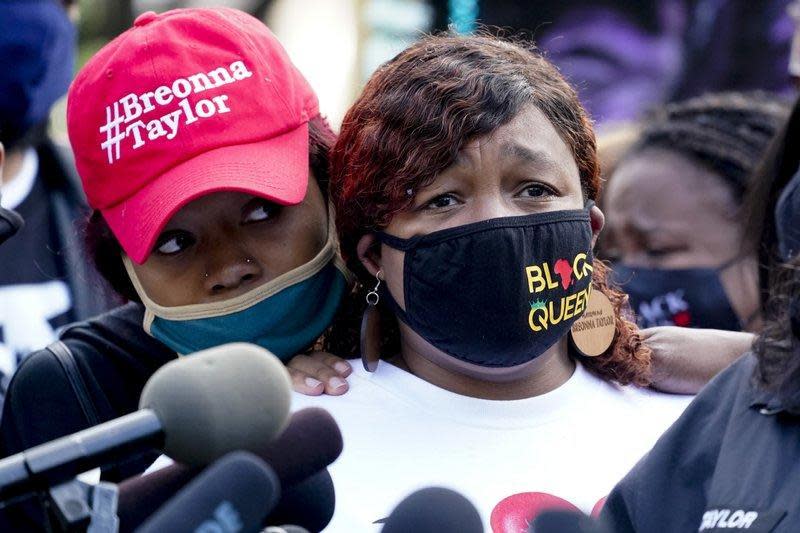 Tamika Palmer, right, the mother of Breonna Taylor, listens to a news conference, Friday, Sept. 25, 2020, in Louisville, Ky. as attorneys demand the release of grand jury transcripts in Taylor's death. / Credit: AP Photo/Darron Cummings