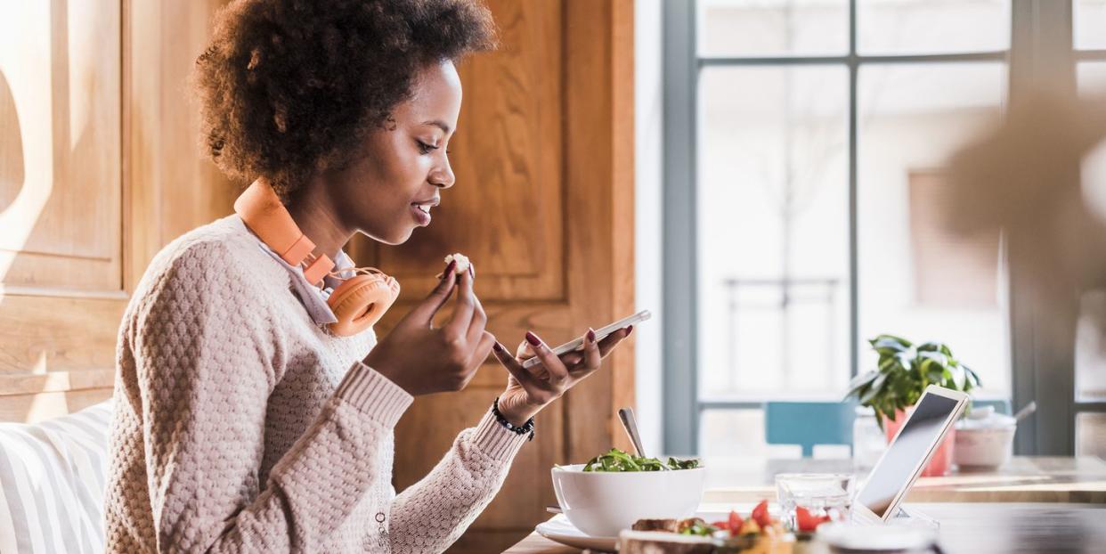 young woman using cell phone in a cafe