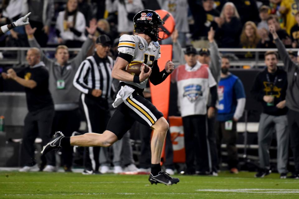 Missouri quarterback Brady Cook carries the ball on the way to the end zone for a touchdown during the first half against Army in the Armed Forces Bowl in Fort Worth, Texas.