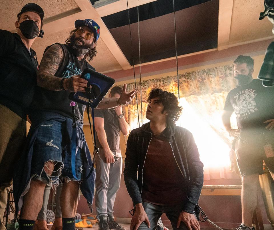 Director Ángel Manuel Soto, left, and Xolo Maridueña on the set of "Blue Beetle."