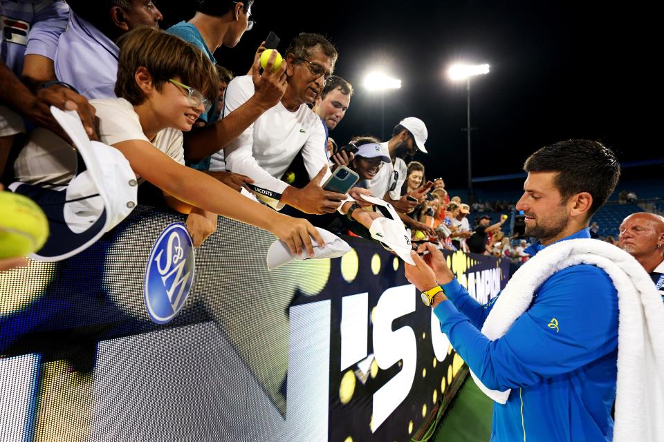 Novak Djokovic, of Serbia, signs autographs for fans after defeating Carlos Alcaraz, of Spain, at the conclusion of the men’s singles final of the Western & Southern Open tennis tournament, Sunday, Aug. 20, 2023, at the Lindner Family Tennis Center in Mason, Ohio. Djokovic won, 5-7, 7-6, 7-6.