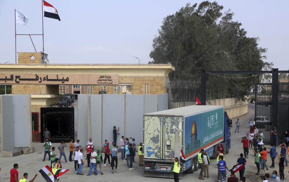 A truck carrying humanitarian aid for the Gaza Strip crosses the Rafah border gate in Rafah, Egypt, Sunday, Oct. 22, 2023. (AP Photo/Mohammed Asad)