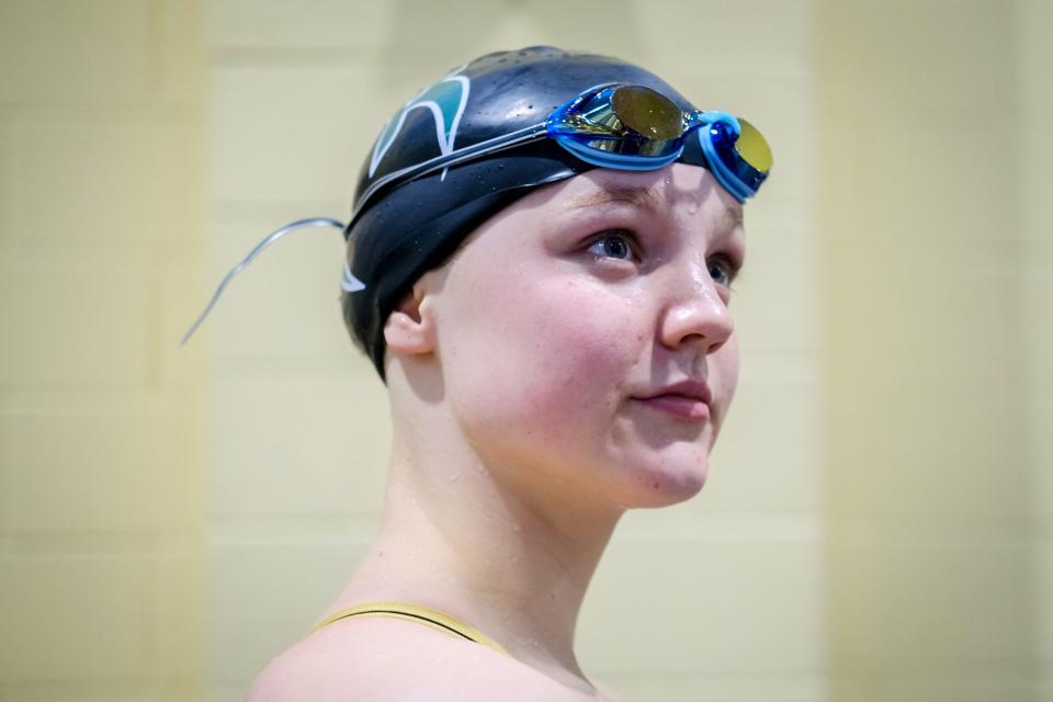 Fossil Ridge’s Ella Gaca-Thiele waits to receive another medal at the Colorado 5A girls swimming state championships on Friday at Veterans Memorial Aquatics Center in Thornton.