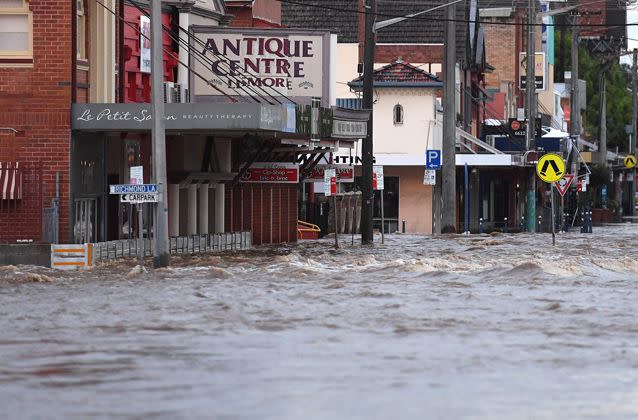 Flood waters rush through the centre of Lismore. Picture: AAP