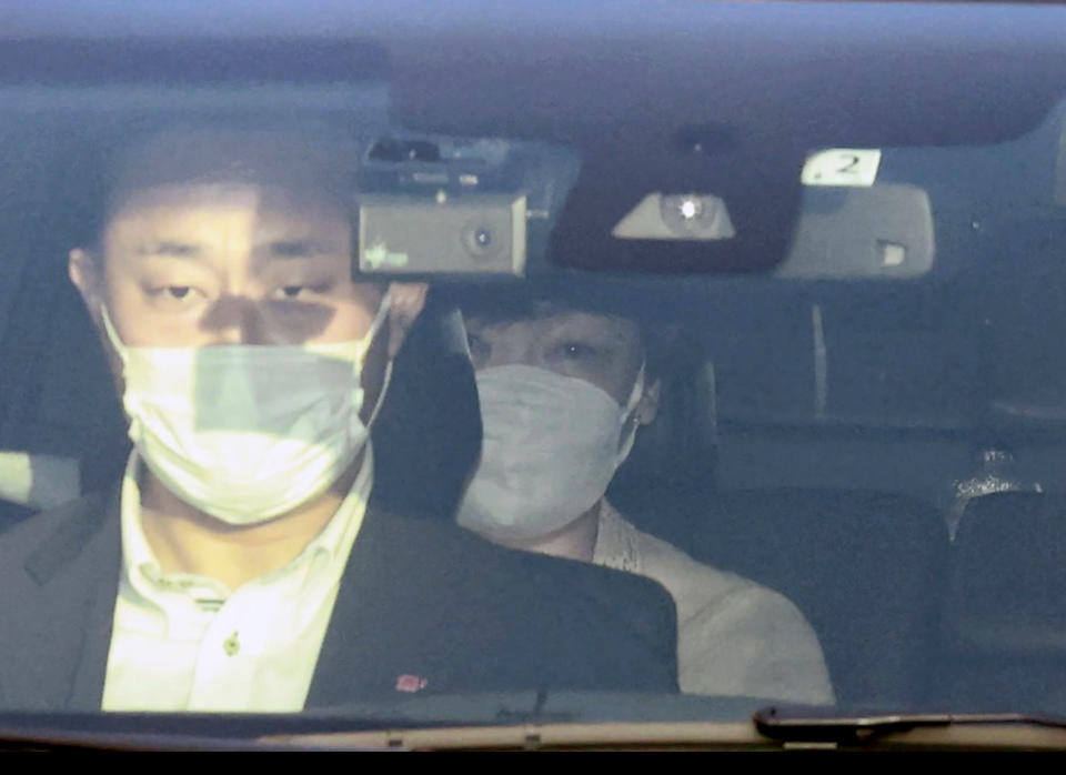 Akie Abe, rear, wife of Japan's former Prime Minister Shinzo Abe, sits in a hearse which is believed to carry the body of Japan's former Prime Minister Shinzo Abe, as the car leaves a hospital in Kashihara, Nara prefecture, western Japan Saturday, July 9, 2022. Former Prime Minister Abe, 67, was shot from behind in Nara in western Japan while giving a campaign speech. He was airlifted to a hospital and later pronounced dead. (Kyodo News via AP)