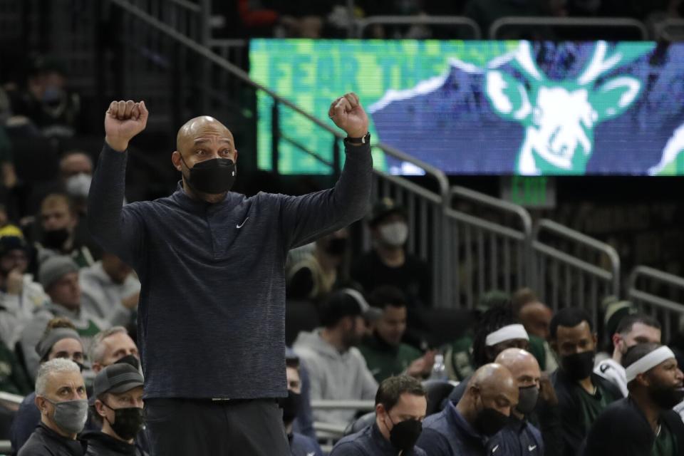 Milwaukee Bucks assistant coach Darvin Ham gestures from the sideline.