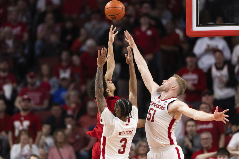 Rutgers' Derek Simpson, top left, shoots against Nebraska's Brice Williams (3) and Rienk Mast (51) during the first half of an NCAA college basketball game Sunday, March 3, 2024, in Lincoln, Neb. (AP Photo/Rebecca S. Gratz)