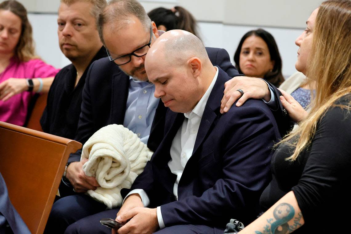 Ryan Petty comforts Ilan Alhadeff as they await the verdict in the trial of Marjory Stoneman Douglas High School shooter Nikolas Cruz at the Broward County Courthouse in Fort Lauderdale on Thursday, Oct. 13, 2022. Petty’s daughter, Alaina, and Alhadeff’s daughter, Alyssa, were killed in the 2018 shootings. Cruz pleaded guilty to 17 counts of premeditated murder in the 2018 shootings.
