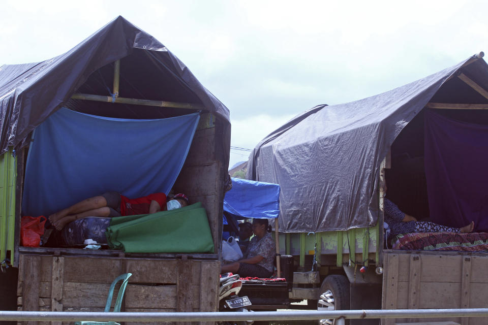 <p>Villagers rest in their truck as a temporary shelter in Klungkung, Bali, Indonesia on Sept. 23, 2017. Thousands of villagers on the Indonesian resort island of Bali are sheltering in sports centers, village halls and with relatives, fearing Mount Agung will erupt for the first time in more than half a century. (AP Photo/Firdia Lisnawati) </p>