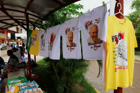 People sell shirts with images of Pope Francis along a street in Puerto Maldonado, ahead of the papal's visit to Peru, January 18, 2018. REUTERS/Henry Romero NO RESALES. NO ARCHIVES.