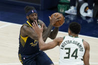 Indiana Pacers' JaKarr Sampson (14) goes to the basket against Milwaukee Bucks' Giannis Antetokounmpo (34) during the first half of an NBA basketball game Thursday, May 13, 2021, in Indianapolis. (AP Photo/Darron Cummings)