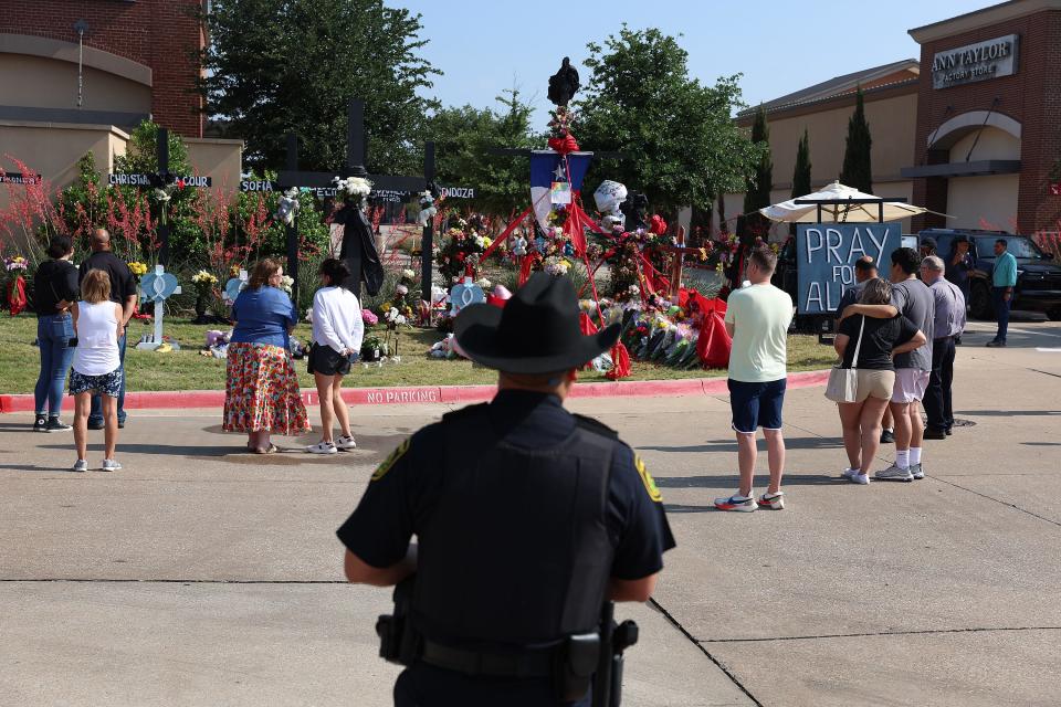 People visit a memorial near the scene of a mass shooting at the Allen Premium Outlets mall in Allen, Texas, May 9, 2023.