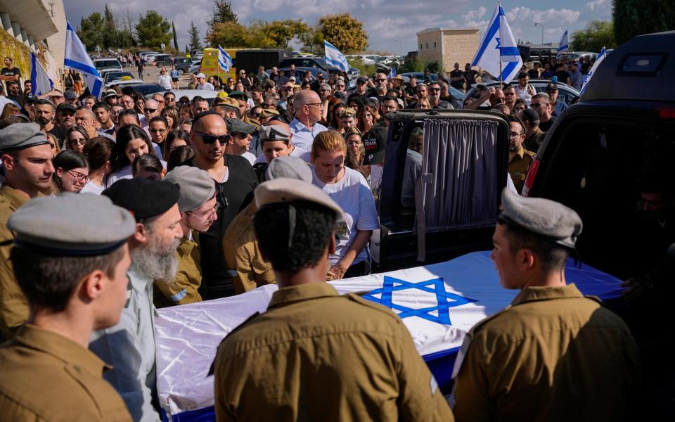 Israeli soldiers carry the flag-draped casket of Corporal. Noa Marciano, during her funeral in Modiin, Israel