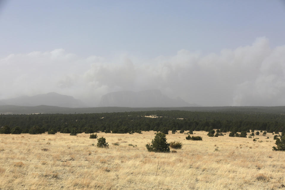 Plumes of smoke rise from a pair of growing wildfires in northeast New Mexico on Friday, April 22, 2022 outside Las Vegas, N.M.. Southwest fires have burned dozens of homes in northern Arizona and put numerous small villages in New Mexico in the path of danger. (AP Photo/Cedar Attanasio)