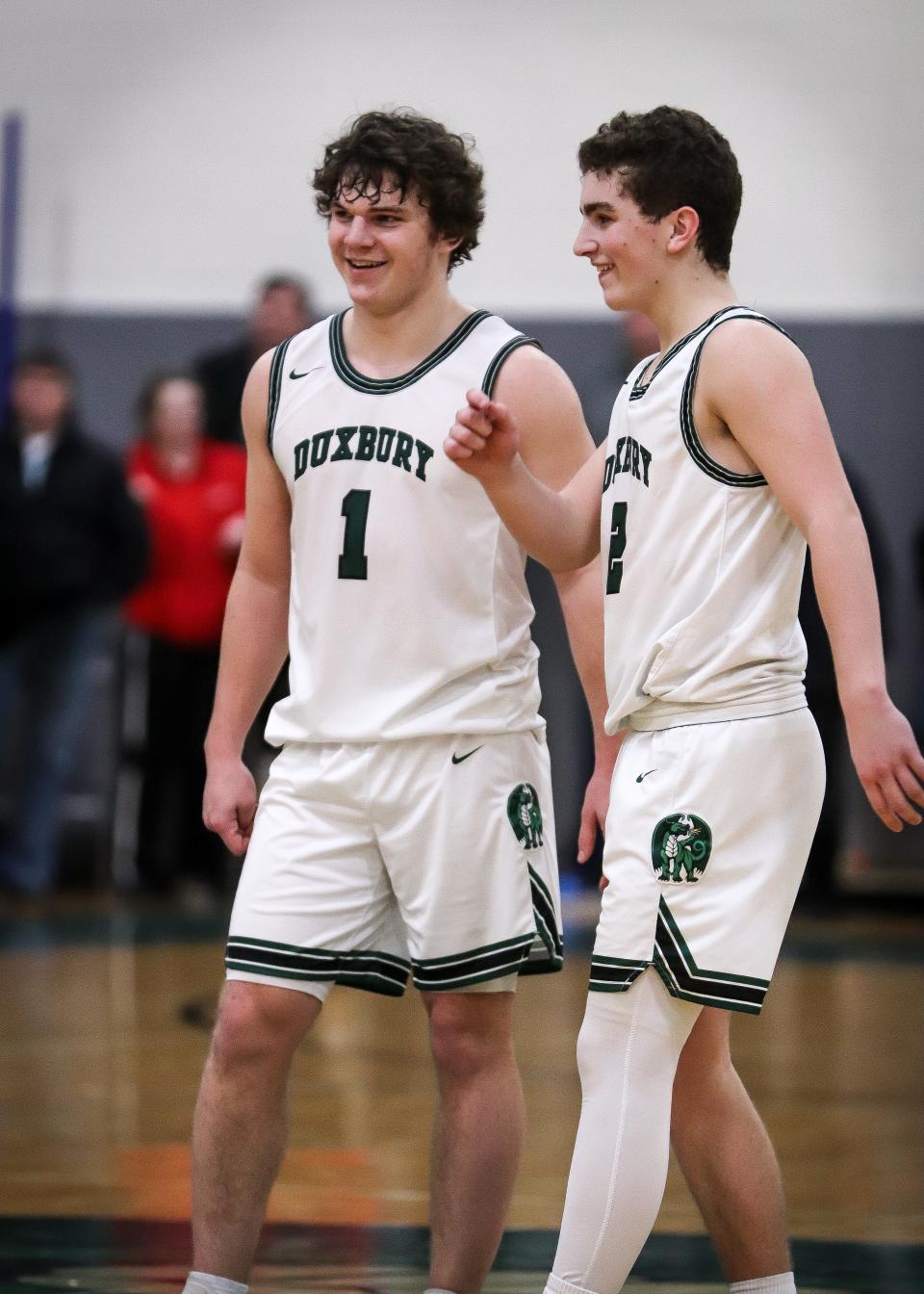 Duxbury's Alex Barlow, left, shares a smile with Trevor Jones during a game against Falmouth on Friday, Feb. 17, 2023.