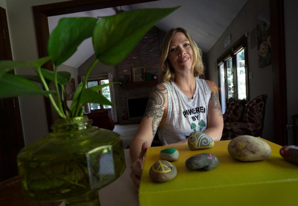 Melissa Routt shows some of her decorated rocks for her Fishers Rocks! group Tuesday, May 31, 2022 at her home in Fishers. She and others paint rocks and hide them in public for people to find to brighten the day of the people who find them.