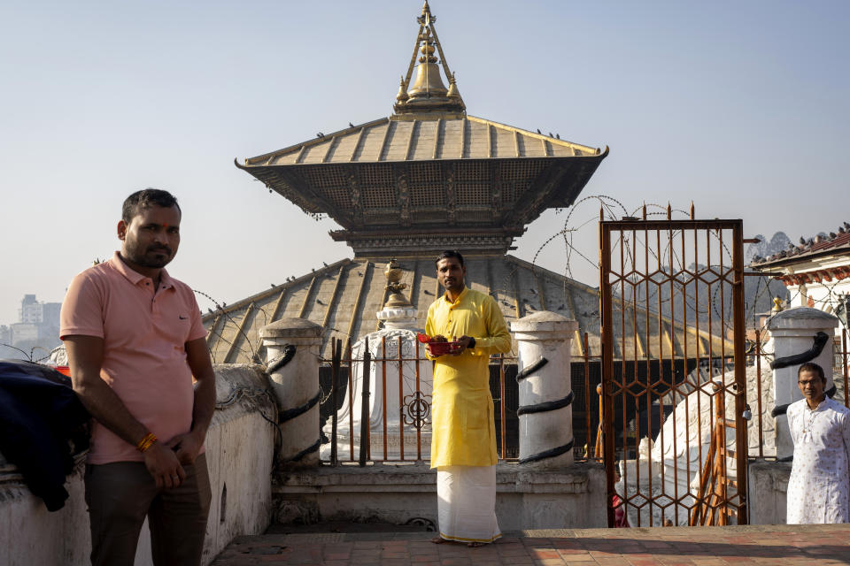 Kamalesh Verma, center, a 31-year-old devotee from India's eastern Chhattisgarh state, visits Pashupatinath temple in Kathmandu, Nepal, Jan. 10, 2024. "This is the first time I'm here at Pashupatinath temple, but I don't know if it's God's will that I will return to receive his blessings." Nepal and India are the world’s two Hindu-majority nations and share a strong religious affinity. Every year, millions of Nepalese and Indians visit Hindu shrines in both countries to pray for success and the well-being of their loved ones. (AP Photo/Niranjan Shrestha)