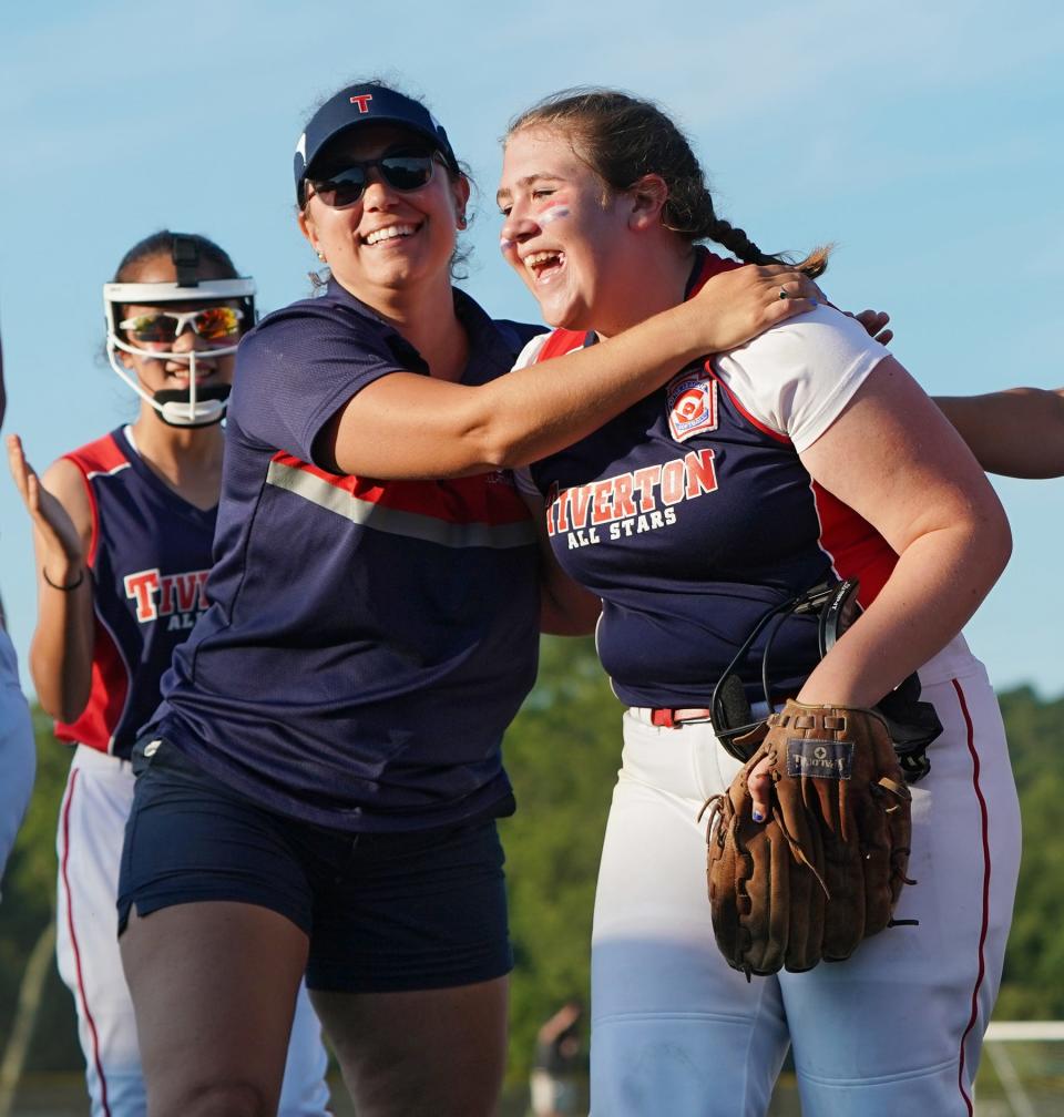 Tiverton softball assistant coach Jess Silvia hugs pitcher Adalie Wolfe on Wednesday night after Tiverton beat South Kingstown 13-1 to win the state championship.