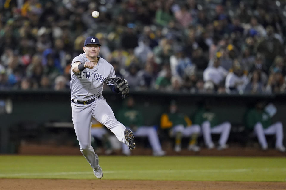 New York Yankees third baseman Josh Donaldson throws to first for an out against Oakland Athletics' Chad Pinder during the ninth inning of a baseball game in Oakland, Calif., Saturday, Aug. 27, 2022. (AP Photo/Godofredo A. Vásquez)