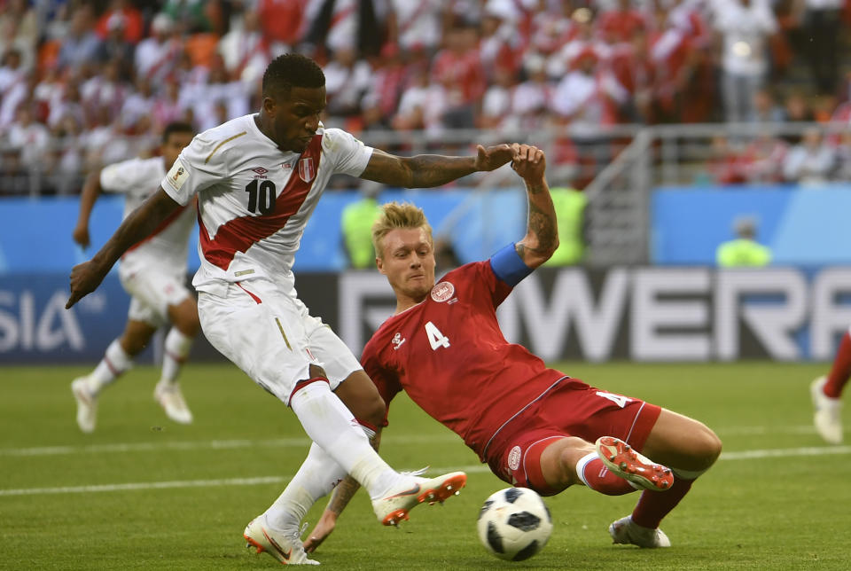 <p>Duelers: Peru’s Jefferson Farfan tries to keep the ball under pressure from Simon Kjaer. (AP) </p>