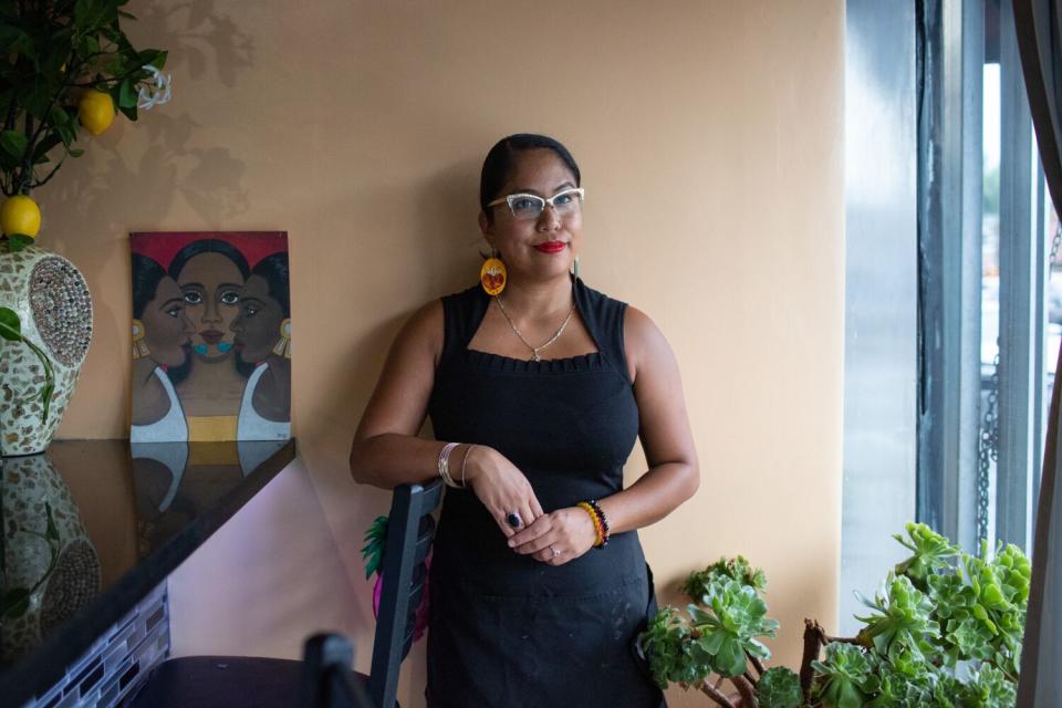 A woman stands in a restaurant