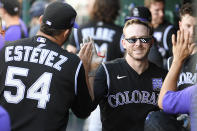 Colorado Rockies' Trevor Story, front right, celebrates his three-run home run with Carlos Estevez (54) and others in the dugout during the fourth inning of a baseball game against the Washington Nationals, Saturday, Sept. 18, 2021, in Washington. (AP Photo/Nick Wass)