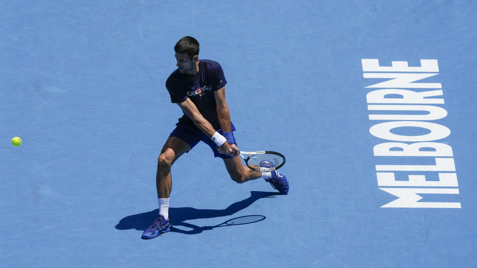 Defending men's champion Serbia's Novak Djokovic practices on Rod Laver Arena ahead of the Australian Open tennis championship in Melbourne, Australia, Wednesday, Jan. 12, 2022. AP Photo/Mark Baker)