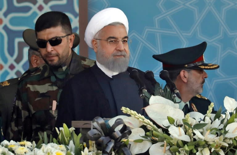 Iranian President Hassan Rouhani, flanked by army top brass at a military parade in Tehran on September 22, 2017, vows he will never seek anybody's permission to boost his country's defences