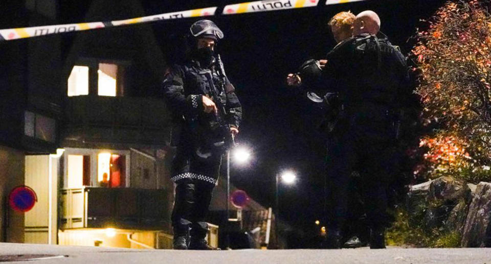 Police officers cordon off the scene where they are investigating in Kongsberg, Norway after a man armed with bow killed several people before he was arrested by police.