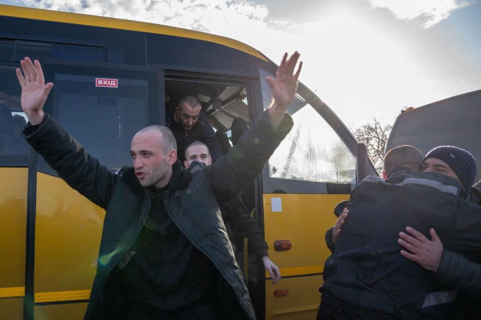 Ukrainian prisoners of war (POWs) react after a swap, amid Russia’s attack on Ukraine, at an unknown location in Ukraine (via REUTERS)