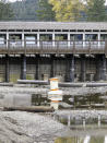 Water flows have slowed to a trickle through the dam at Lake Tahoe at the mouth of the Truckee River in Wednesday, Oct. 20, 2021 at Tahoe City, Calif.. Drought fueled by climate change has dropped Lake Tahoe below its natural rim and halted flows into the Truckee River, an historically cyclical event that's occurring sooner and more often than it used to raising fears about what might be in store for the famed alpine lake. (AP Photo/Scott Sonner).