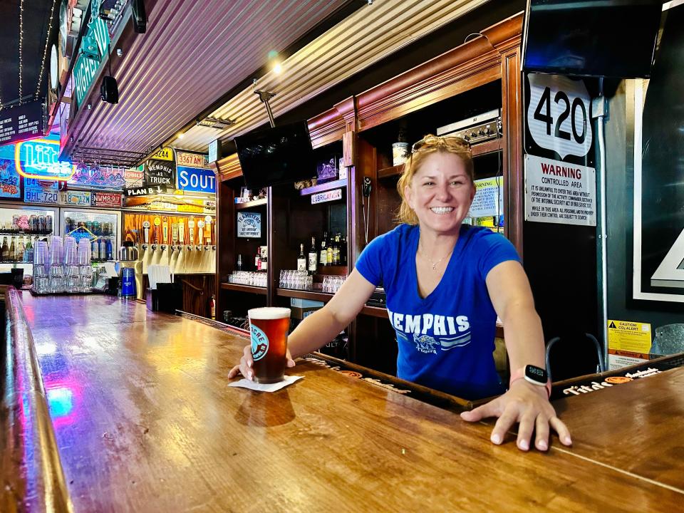 Adrienne Lacinda, the general manager, serves a beer at Momma's bar and restaurant in Downtown Memphis.