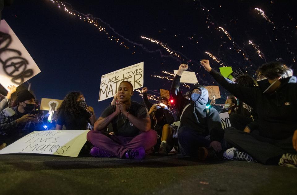 Michelle Usher prays during a demonstration for racial justice in Santa Ana on May 30.