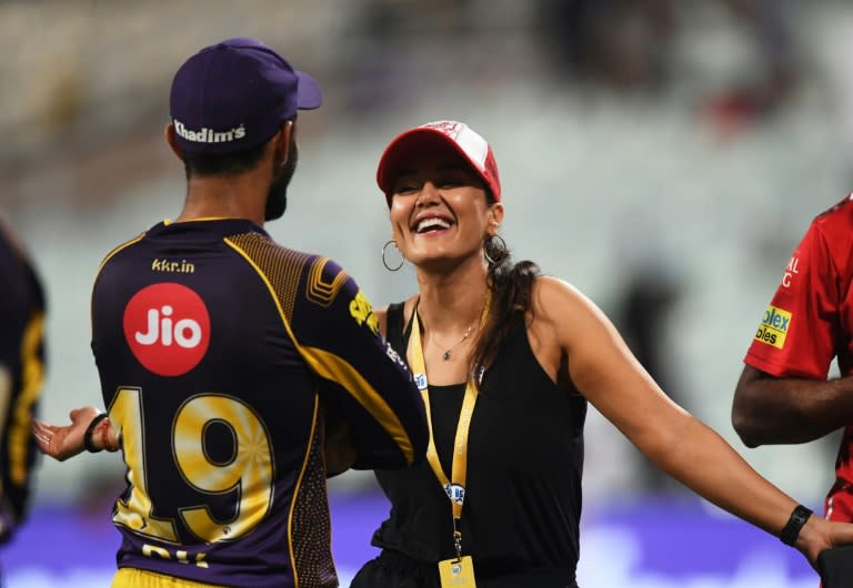 Indian actress and Kings XI Punjab co-owner Preity Zinta talks with Kolkata Knight Riders captain Dinesh Karthik after a game. The IPL has been dubbed a "perfect storm with elements of the Champions League, pro wrestling and a touch of Bollywood"