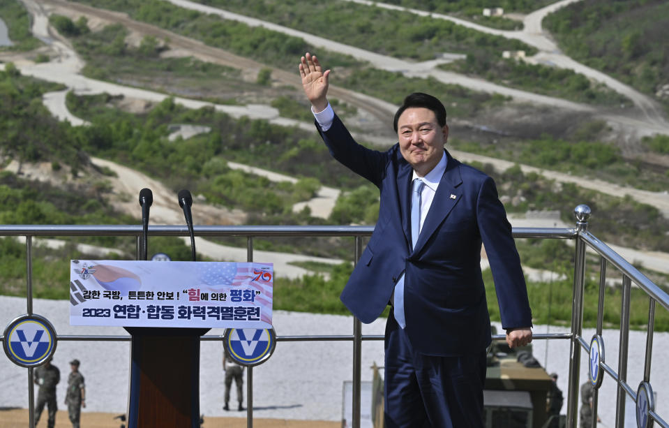 South Korean President Yoon Suk Yeol waves as he delivers a speech after a South Korea-U.S. joint military drill at Seungjin Fire Training Field in Pocheon, South Korea Thursday, June 15, 2023. (Jung Yeon-je/Pool Photo via AP)