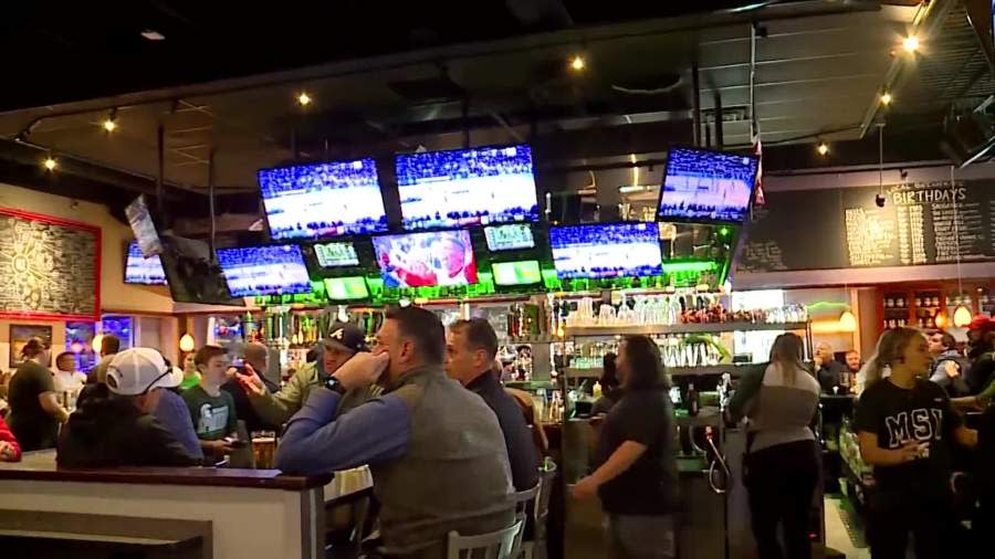 Basketball fans watch Michigan State play in the NCAA Tournament at The Score Restaurant & Sports Bar near Grand Rapids on March 21, 2024.