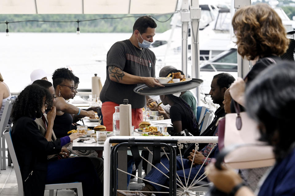 A waiter works at a restaurant in Alexandria, Virginia, on June 3, 2022. - US employers added 390,000 jobs last month, the US Labor Department reported on June 3, 2022, a sign of a slowdown in hiring but still a better-than-expected result. Restaurants and hotels that were decimated due to Covid-19 showed a strong recovery in May, adding 84,000 positions, the data showed. (Photo by OLIVIER DOULIERY / AFP) (Photo by OLIVIER DOULIERY/AFP via Getty Images)