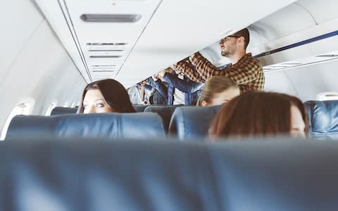 Airlines are having to deal with overhead locker congestion - Credit: Getty