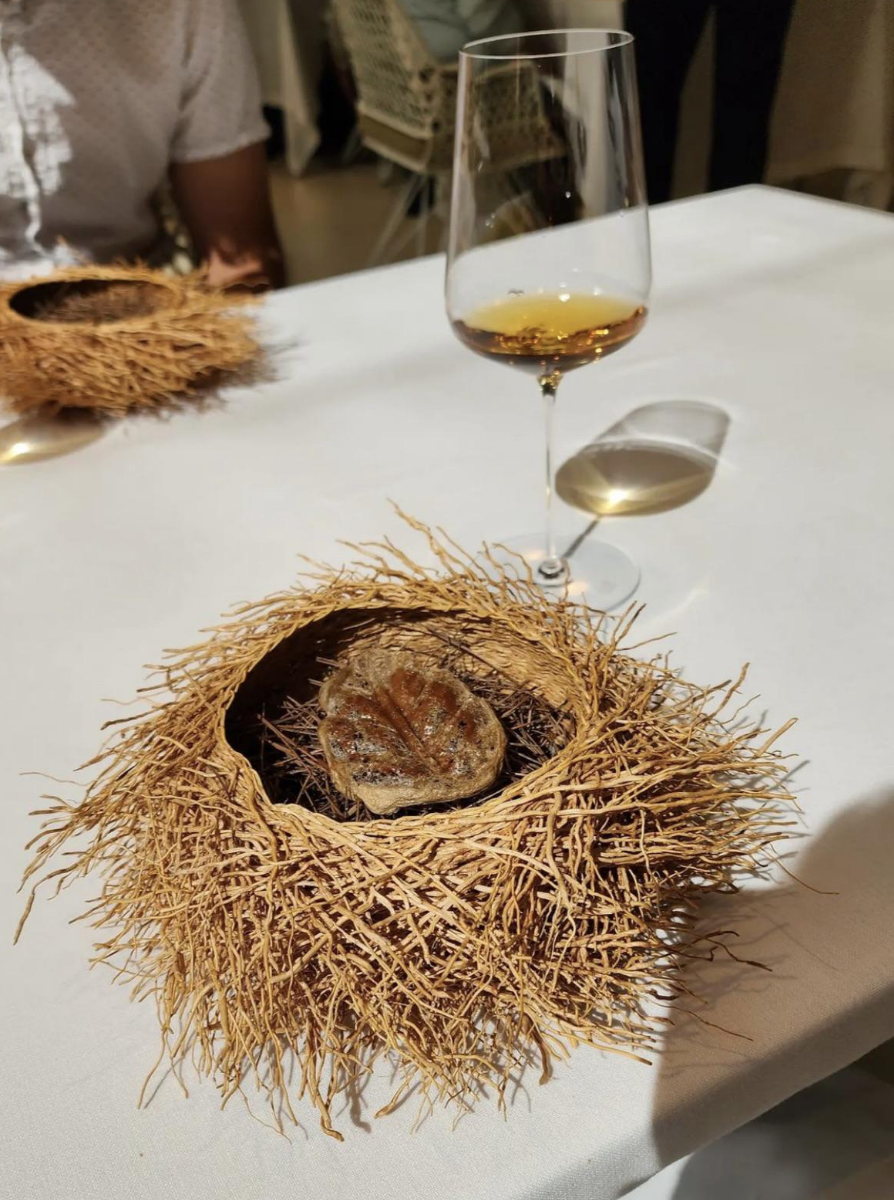 A single piece of meat served inside what looks like a real bird's nest