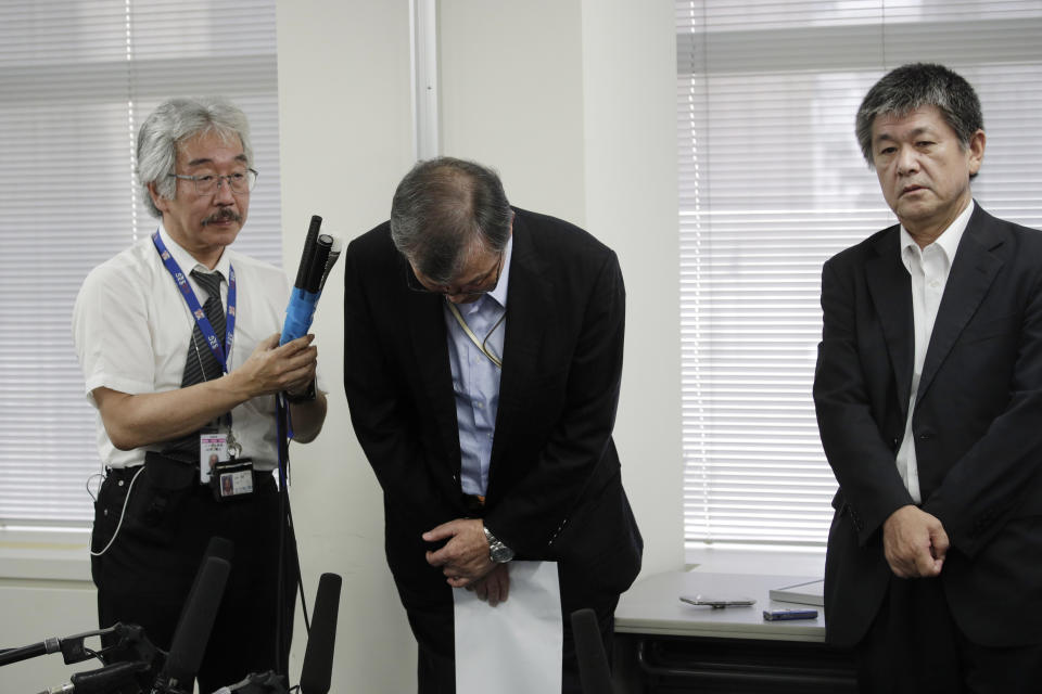Yutaka Katada, center, president of Kokuka Sangyo Co., the Japanese company operating one of two oil tankers attacked near the Strait of Hormuz, bows after talking to reporters at a news conference Friday, June 14, 2019, in Tokyo. Iran rejects a U.S. accusation against Tehran over suspected attacks on two oil tankers near the strategic Strait of Hormuz. (AP Photo/Jae C. Hong)
