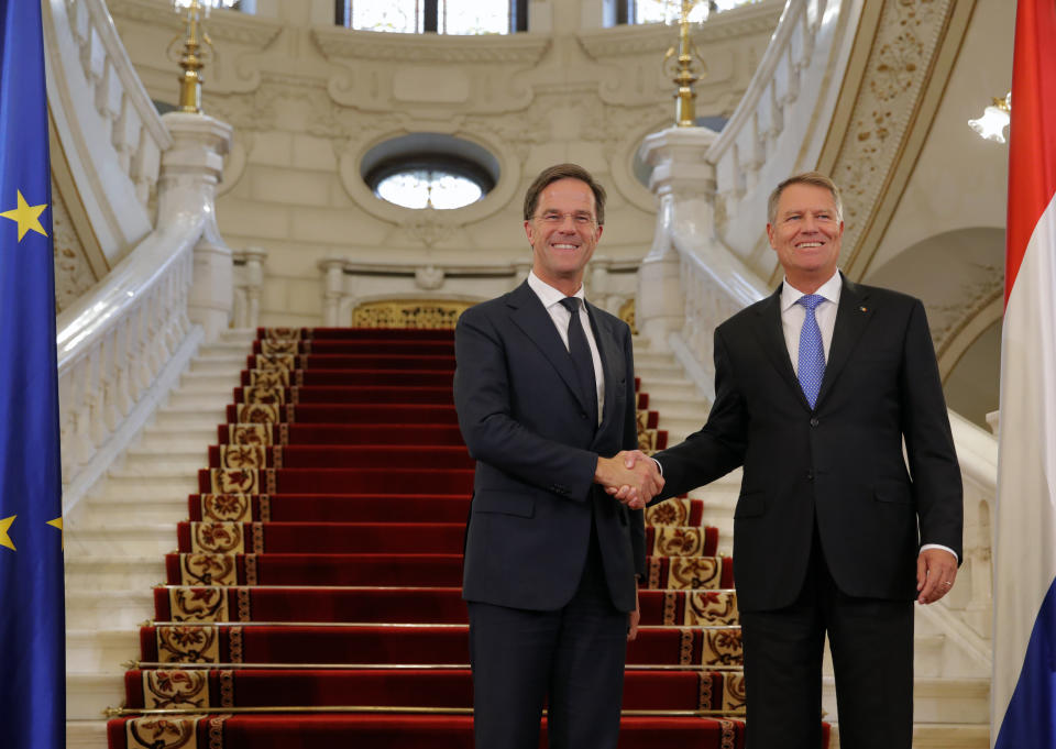 Dutch Prime Minister Mark Rutte, left, shakes hands with Romanian President Klaus Iohannis at the Cotroceni Presidential Palace in Bucharest, Romania, Wednesday, Sept. 12, 2018. Rutte is on a one day official visit to Romania.(AP Photo/Vadim Ghirda)