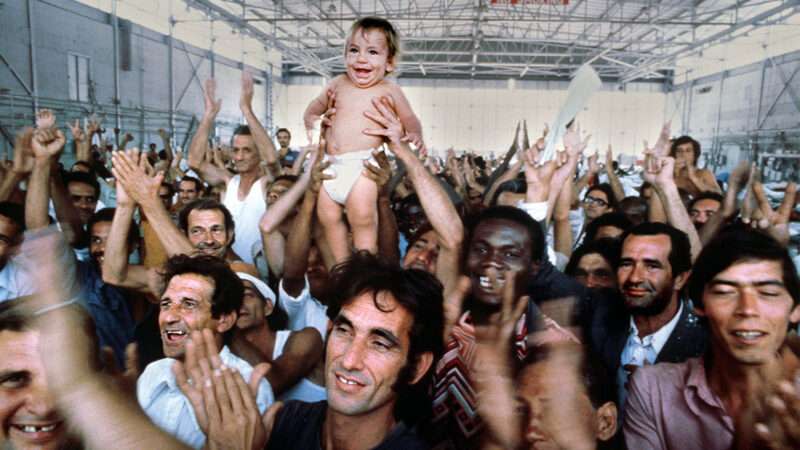 Mariel Boat Lift refugees holding up a child