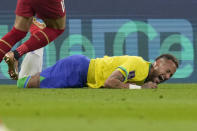 Brazil's Neymar grimaces as he falls to the ground during the World Cup group G soccer match between Brazil and Serbia, at the Lusail Stadium in Lusail, Qatar, Thursday, Nov. 24, 2022. (AP Photo/Andre Penner)