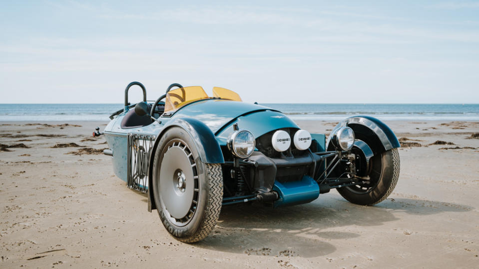 The Morgan Super 3 three-wheeler on a beach in Wales.