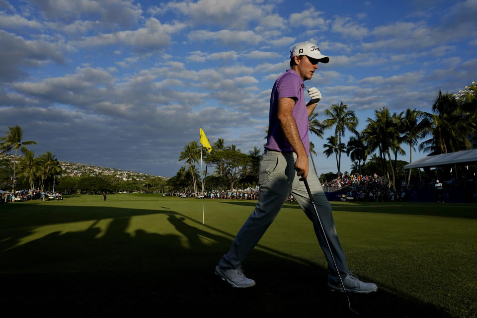 Russell Henley walks off the 18th green to play his shot during a playoff hole of the final round of the Sony Open golf tournament, Sunday, Jan. 16, 2022, at Waialae Country Club in Honolulu. (AP Photo/Matt York)