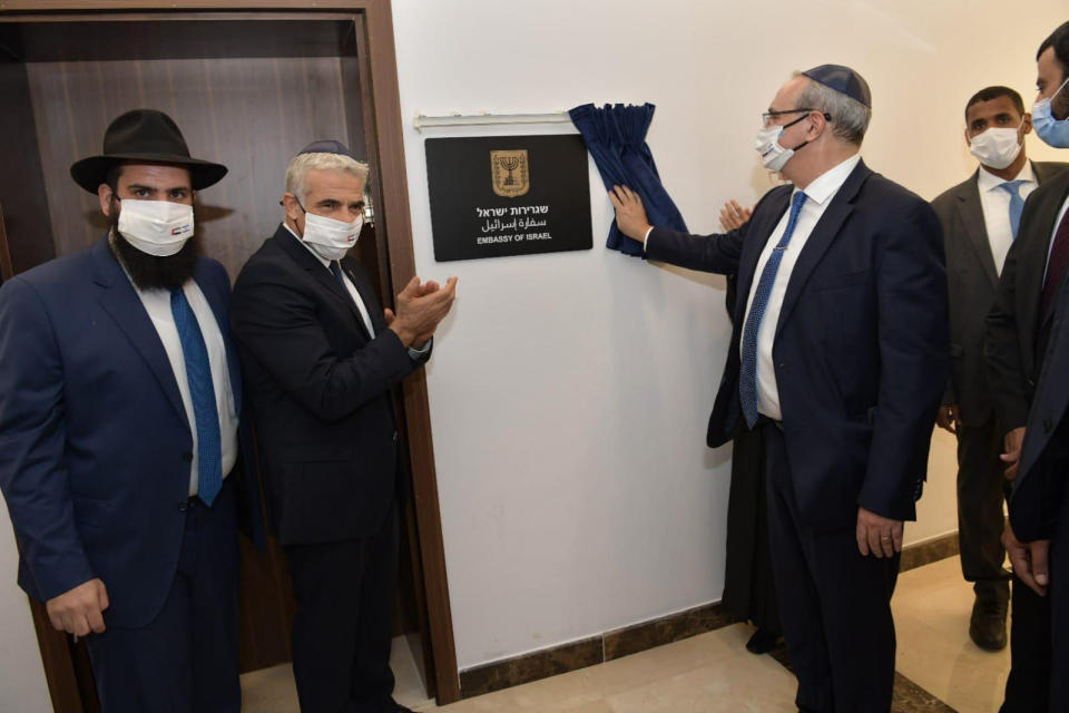 In this photo made available by the Israeli Government Press Office, Israeli Foreign Minister Yair Lapid, second left, attends the inauguration of the Israeli Embassy in Abu Dhabi, United Arab Emirates, Tuesday, June 29, 2021. Israel’s new foreign minister is in the UAE on the first high-level trip by an Israeli official to the Gulf Arab state since the two countries normalized relations last year. (Shlomi Amsalem/Government Press Office via AP)