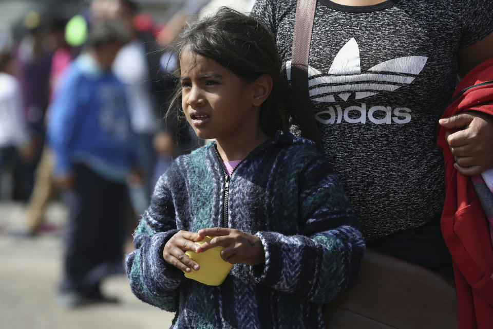 A Central American immigrant family stands in line for food at a sheltered in Piedras Negras, Mexico, Tuesday, Feb. 5, 2019. A caravan of about 1,600 Central American migrants camped Tuesday in the Mexican border city of Piedras Negras, just west of Eagle Pass, Texas. The governor of the northern state of Coahuila described the migrants as "asylum seekers," suggesting all had express intentions of surrendering to U.S. authorities. (Jerry Lara/The San Antonio Express-News via AP)