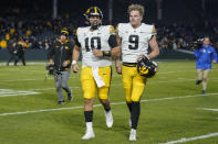 Iowa quarterback Deacon Hill (10) and punter Tory Taylor (9) leave the field after their win over Northwestern in an NCAA college football game Saturday, Nov. 4, 2023, at Wrigley Field in Chicago. (AP Photo/Erin Hooley)