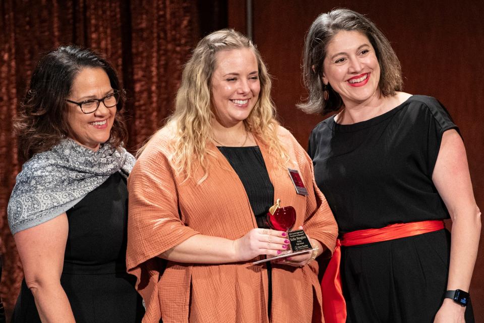 Kellie Menghini, a teacher at McKay High School is awarded a Crystal Apple during the 25th annual Crystal Apple Awards at the Salem Convention Center on Wednesday in Salem.