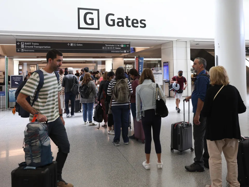 Travelers line up to enter a security checkpoint in the international terminal at San Francisco International Airport on July 01, 2022 in San Francisco, California.